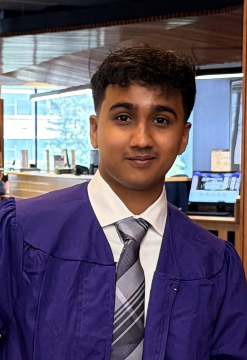 Portrait of Arman Mohiuddin in a graduation gown, shirt and tie